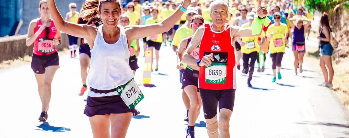 A group of diverse runners participating in a lively marathon event under the sun.